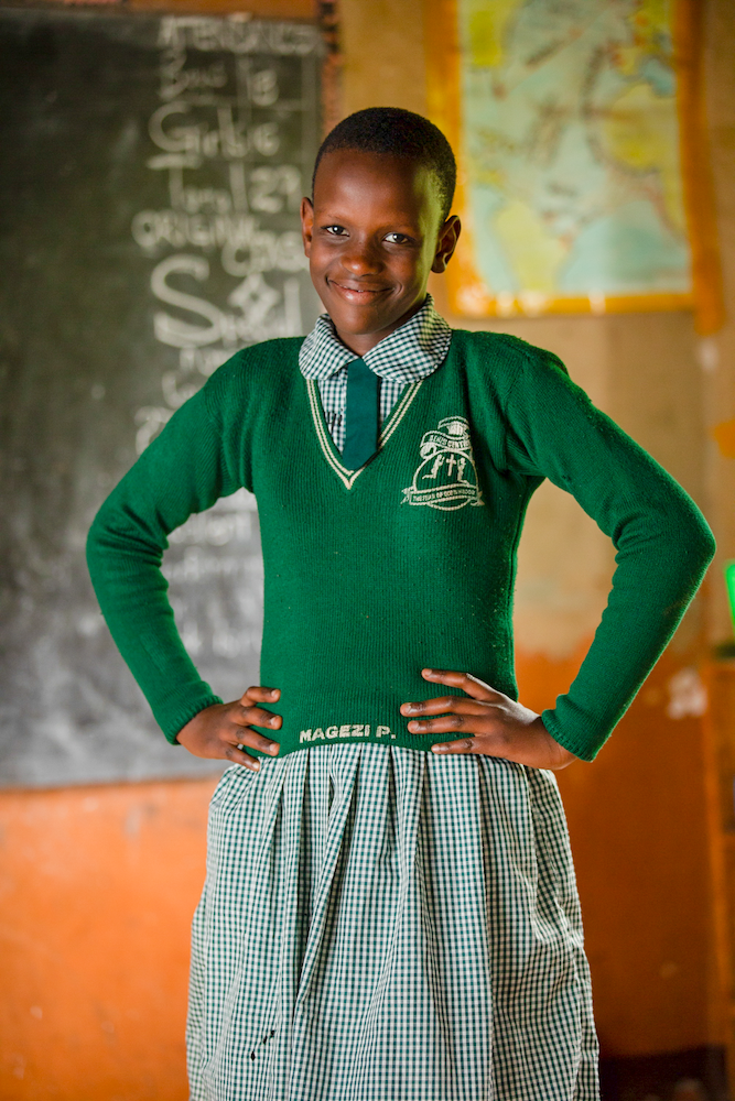 Pamellah stands with her hands on her hips, smiling