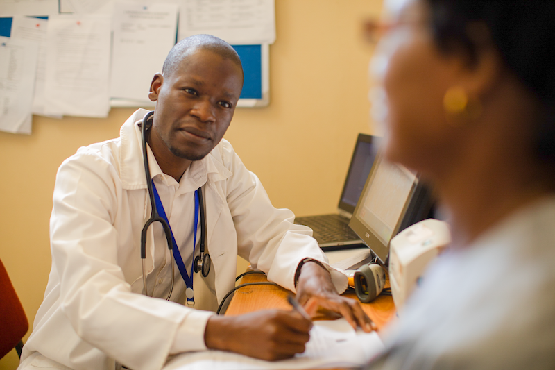 A doctor speaks with a patient in a clinic in Malawi