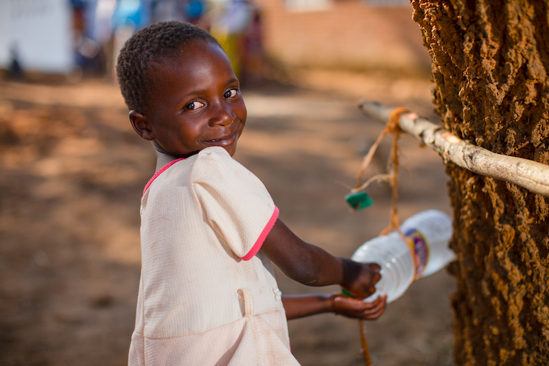 girl washing hands with clean water